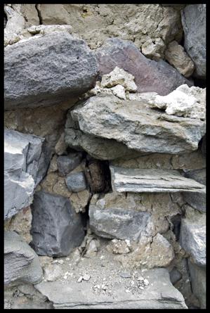 Holes in stonework where shelf brackets were once located