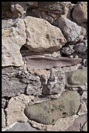 Holes in stonework where shelf brackets were once located