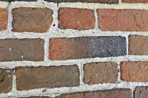 Struck, ruled joints; large charcoal chunks in mortar suggests s