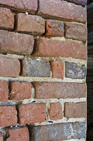 Struck, ruled joints; large charcoal chunks in mortar suggests s