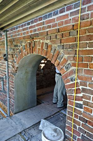 Original compass-headed arch on west face of tower with alternat