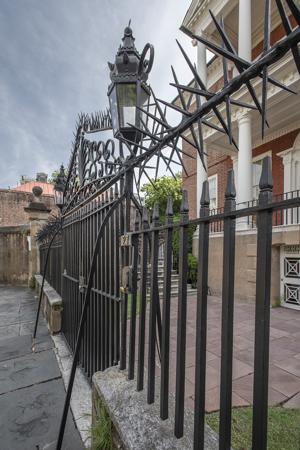 Wrought-iron fence with chevaux de frise cap