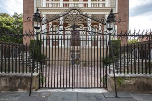 Wrought-iron fence with chevaux de frise cap