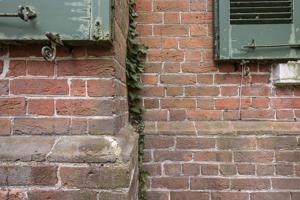Water table made of cast bricks, limited to the approach facade;