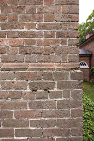 Water table made of cast bricks, limited to the approach facade;