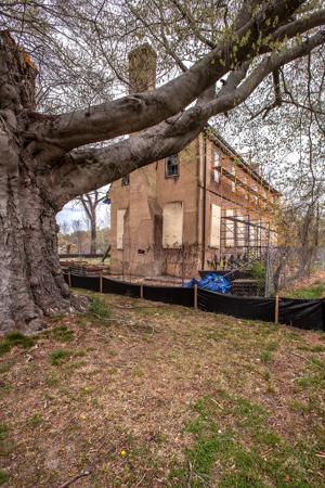 Front of the house raised to two stories and the walls bricked i