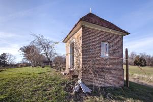 Privy dating to about 1800, set on edge of terraced garden