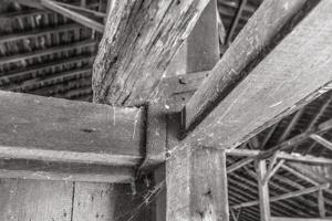 Wrought-iron strap carrying shed joist