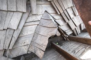 Riven clapboard sheathing bent at the valley of the sttair tower