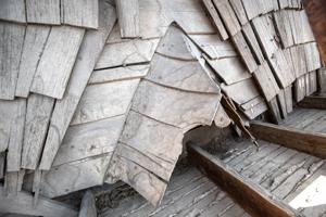 Riven clapboard sheathing bent at the valley of the sttair tower
