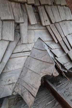 Riven clapboard sheathing bent at the valley of the sttair tower