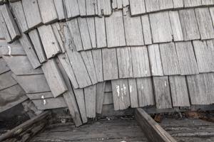 Riven clapboard sheathing bent at the valley of the sttair tower
