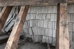 Riven clapboard sheathing bent at the valley of the sttair tower