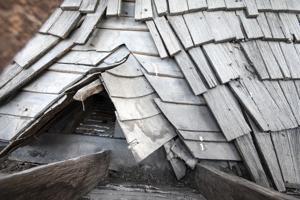 Riven clapboard sheathing bent at the valley of the sttair tower