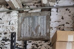 Cellar wall and window shared with earlier spring house