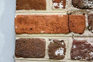 Graffiti carved into bricks