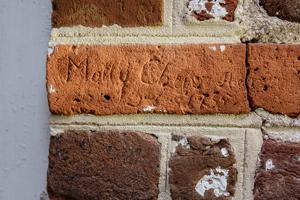 Graffiti carved into bricks