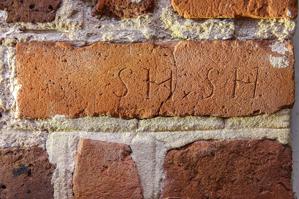 Graffiti carved into bricks