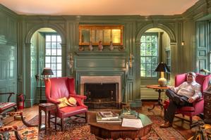 Carl Lounsbury sitting in the dining room of 1784