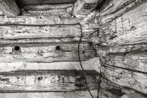 Holes in logs for pegs to carry shelf