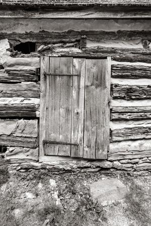 Board-and-batten door hung on hand-forged strap hinges