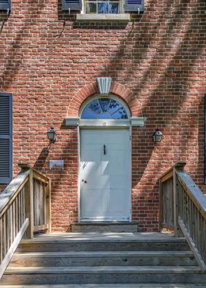 Front door and transom with ghost of original porch; ca. 1812