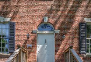 Front door and transom with ghost of original porch; ca. 1812