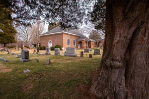 Header-bond church seen across the cemetery