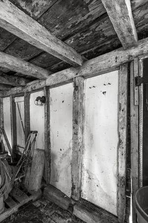 Remnants of wooden hinges for abandoned front doorway