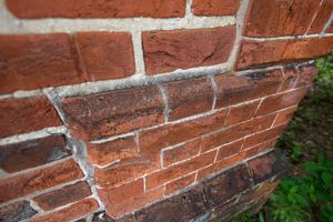 Although rubbed, hammer percussion marks remain visible on quoin