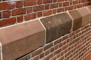 Detail of sandstone water table with lighter Cathedral Stone pat