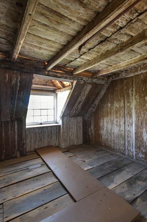 Paneled room in attic with clapboard cockloft, above, 1705