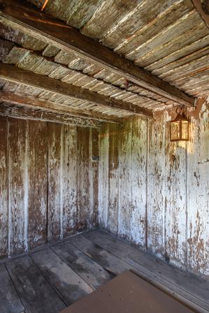 Paneled room in attic with clapboard cockloft, above, 1705