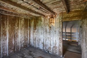 Paneled room in attic with clapboard cockloft, above, 1705