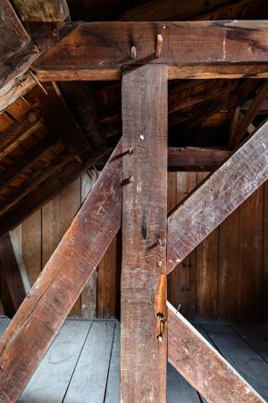 Detail of queen post; struts, and straining beam. Note burn mark