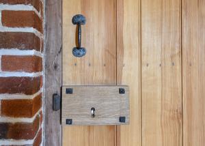 Stock lock and iron handle on kitchen door by Peter Ross