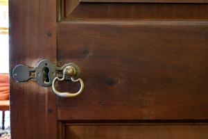 Moortise lock and brass furniture on mahogany drawing room door