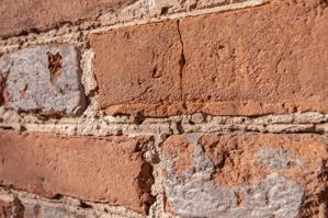 Lip on edge of brick resulting from dragging green brick across 