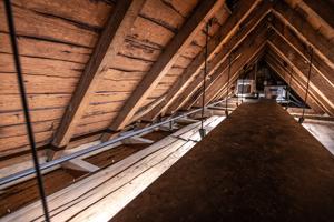 View of upper attic above clapboard floor of the cockloft