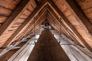 View of upper attic above clapboard floor of the cockloft