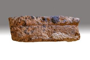 Line scribed on side of brick after firing; water struck, locall