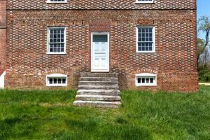 Glazed header Flemish bond facade with evidence of a pent roof; 