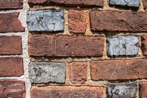 Early graffiti carved into bricks on front