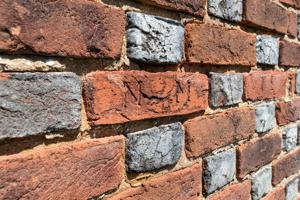 Early graffiti carved into bricks on front