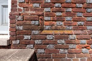 Stepped water table made with cut-and-rubbed bricks on front, 17