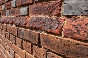 Cut-and-rubbed water table bricks on front; 1722