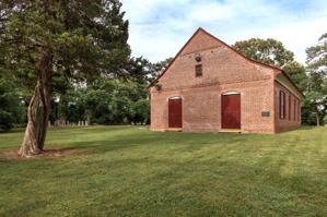 West entrance with glazed-header Flemish bond brickwork; 1733