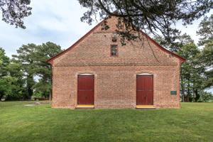 West entrance with glazed-header Flemish bond brickwork; 1733