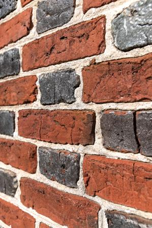 Detail of glazed header Flemish bond made with slop-molded brick