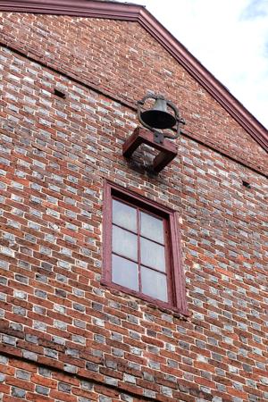 Double string courses and glazing stripped from upper gable; 173